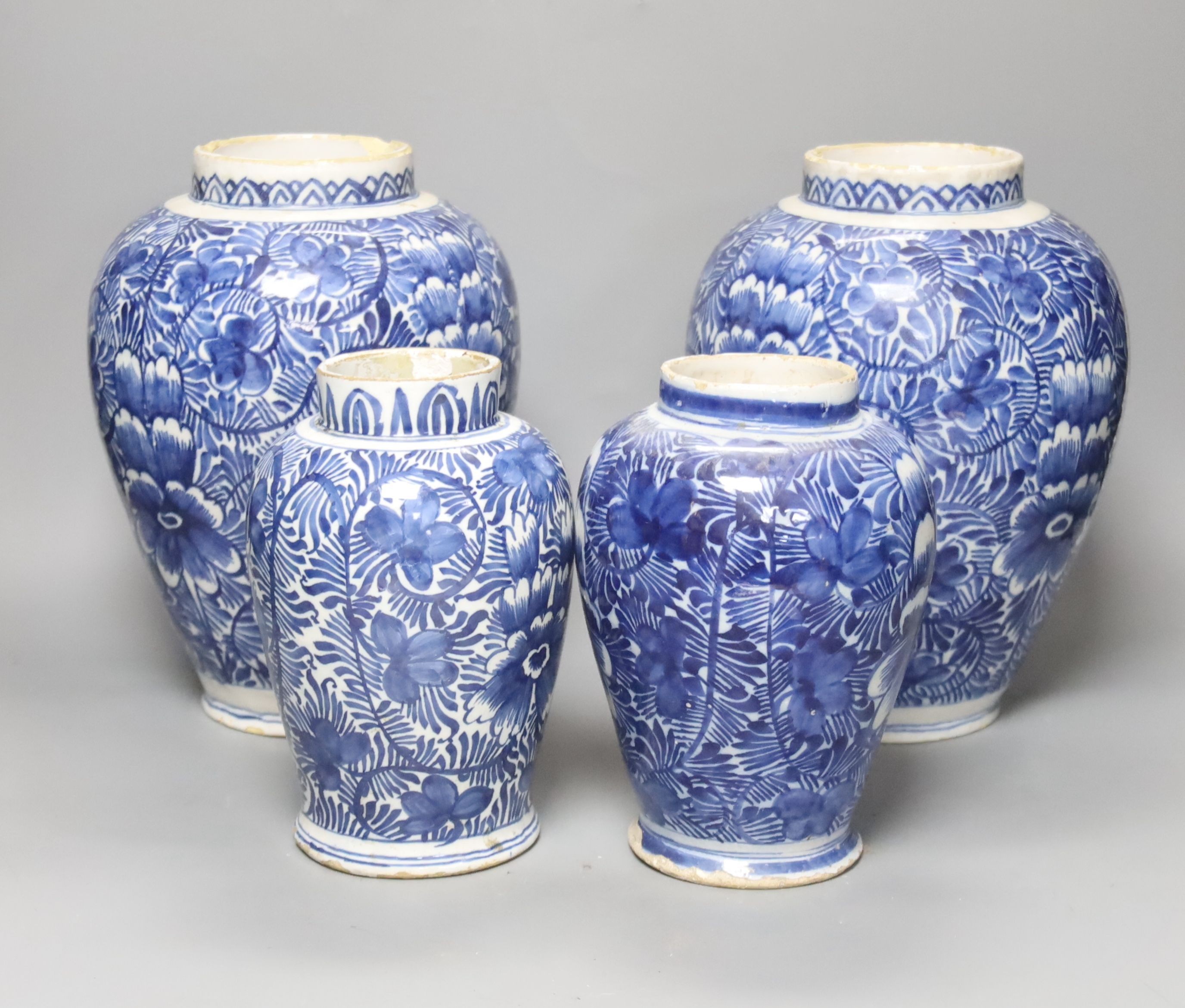 A pair of 18th century Dutch Delft blue and white oviform vases with floral decoration and two similar smaller vases, H 25cm & 19cm